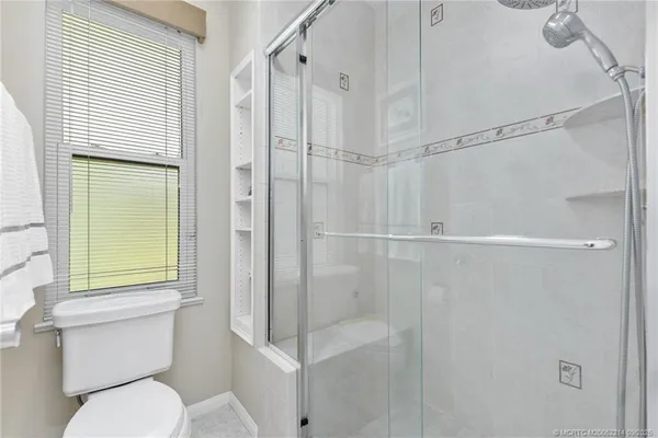 a bathroom with a toilet and a shower