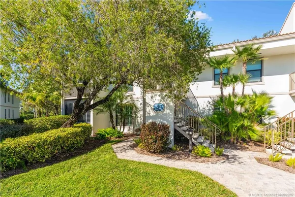 a view of a backyard with plants and patio