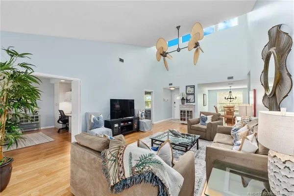 a view of a livingroom with furniture a flat screen tv and a potted plant