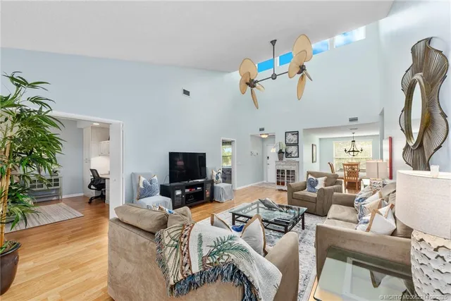 a view of a livingroom with furniture a flat screen tv and a potted plant
