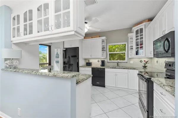 a kitchen with stainless steel appliances granite countertop a sink and cabinets