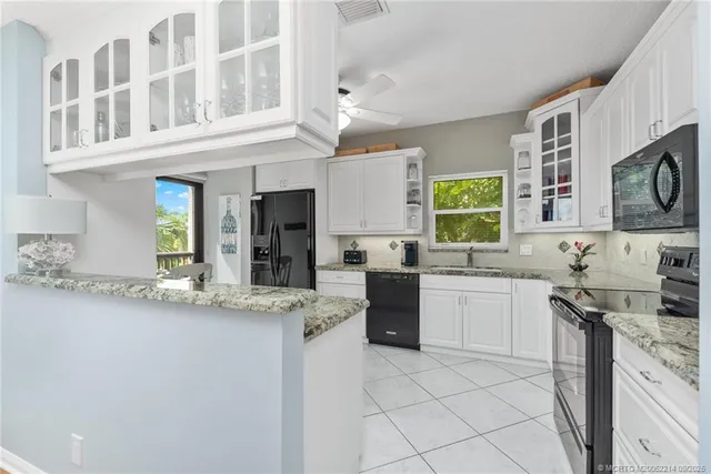 a kitchen with stainless steel appliances granite countertop a sink and cabinets