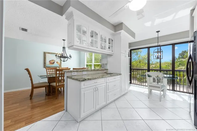 a dining hall with a stove top oven and dining table with garden view
