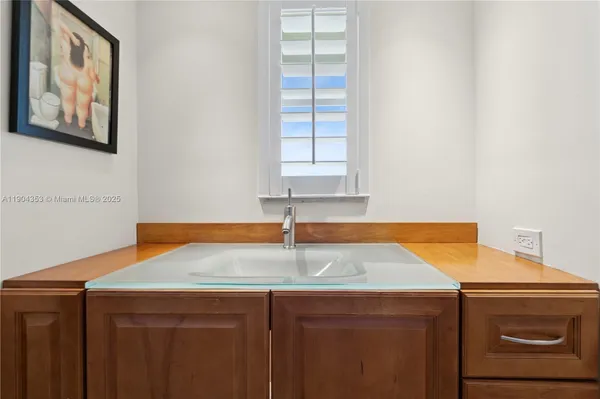 a kitchen with a sink cabinets and a window