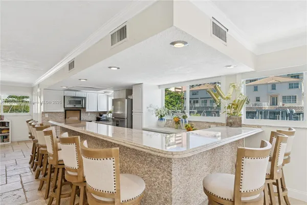 a large kitchen with a table and chairs