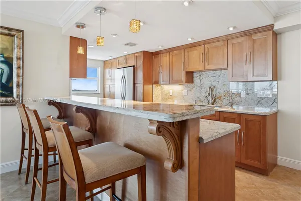 a kitchen with granite countertop a sink and cabinets