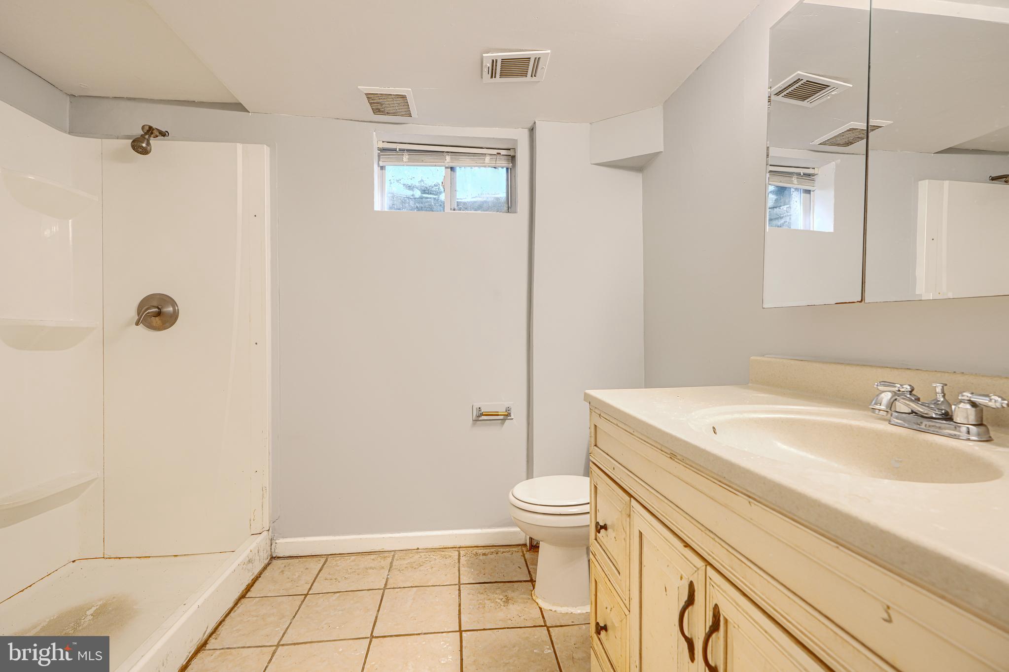 9706 Liberty Road Randallstown, MD 21133 - Photo 42 of 43 a bathroom with a sink a toilet and shower