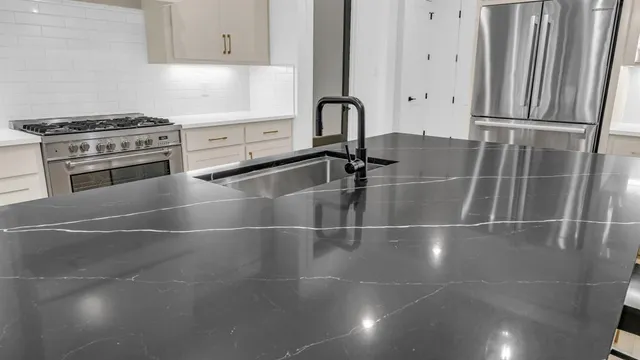 a kitchen with appliances a sink and cabinets