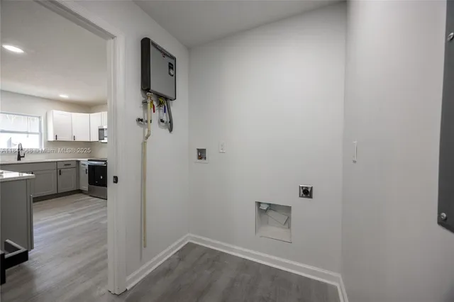 a view of a kitchen with a sink and wooden floor