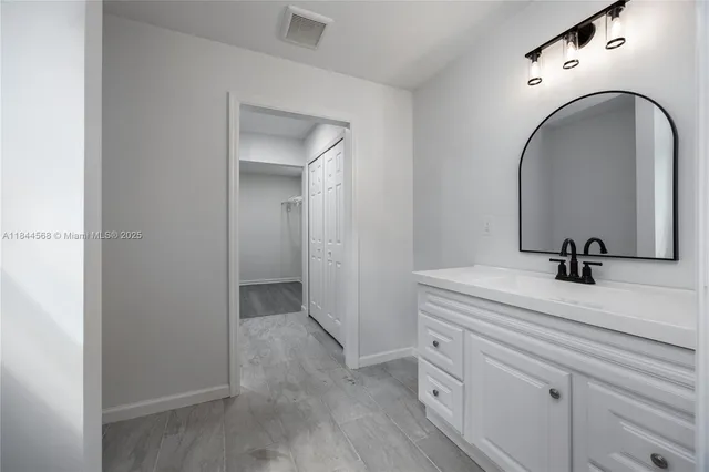 a bathroom with a sink and mirror