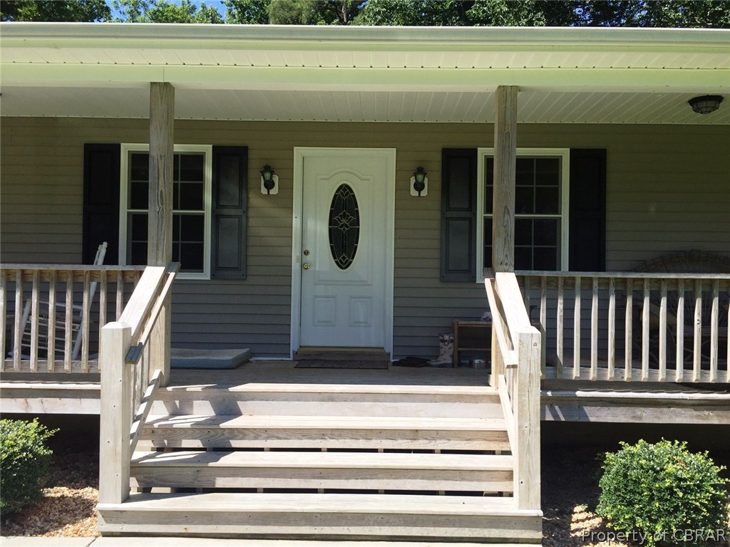 Wide entry steps to inviting porch across the front of the home.