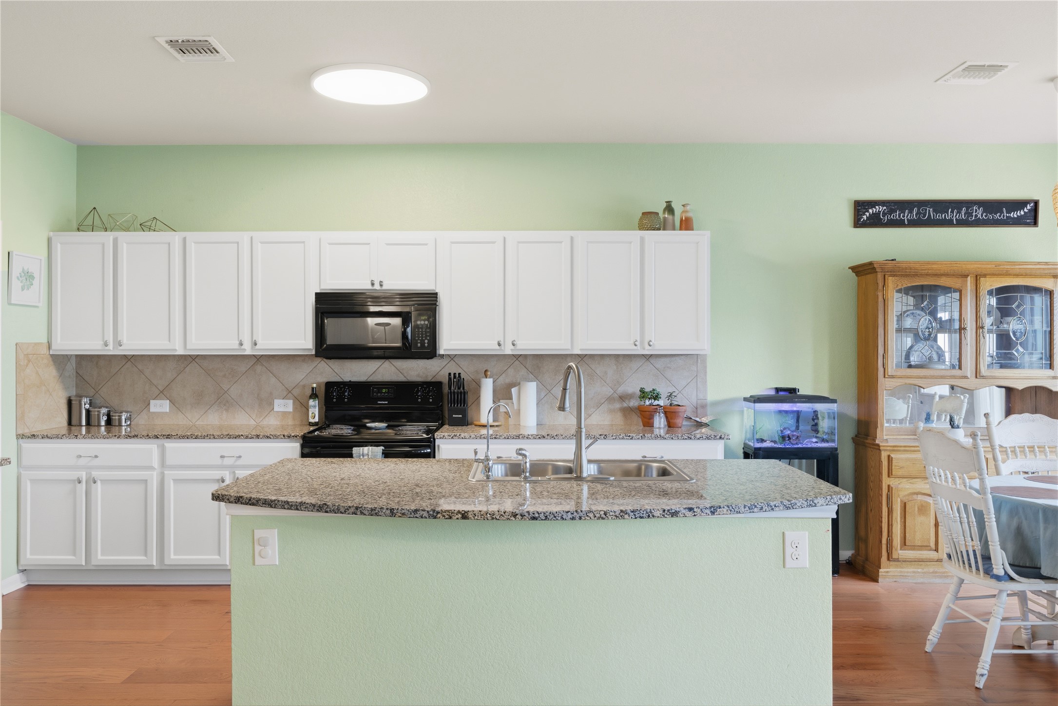 509 Pinnacle Drive Georgetown, TX 78626 - Photo 20 of 25 a kitchen with stainless steel appliances granite countertop a sink stove and microwave