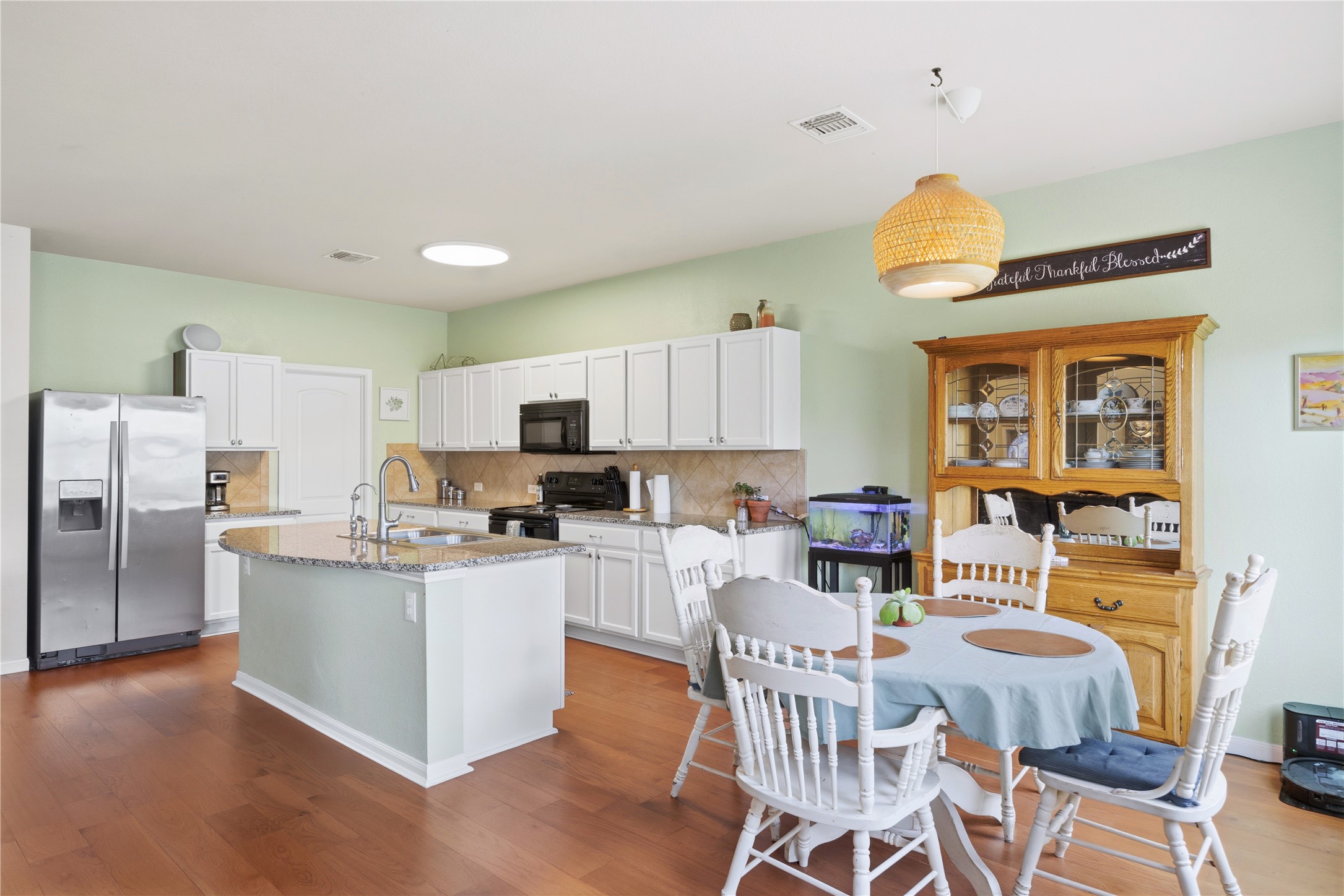 509 Pinnacle Drive Georgetown, TX 78626 - Photo 22 of 25 a kitchen with stainless steel appliances a table and chairs in it