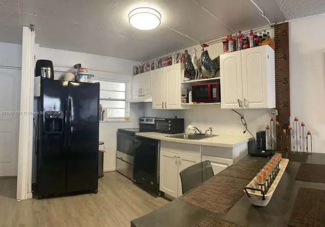 a living room with furniture and a painting on the wall