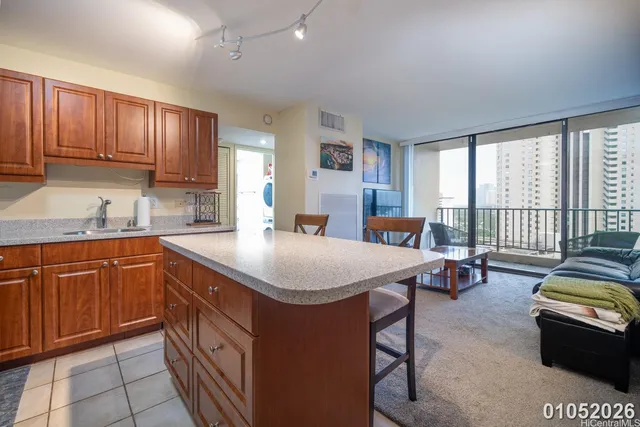 a kitchen with stainless steel appliances granite countertop a sink a stove and a refrigerator