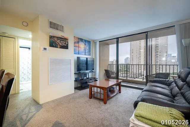 a living room with furniture and a floor to ceiling window