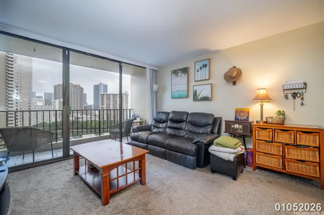 a living room with furniture a lamp and a floor to ceiling window