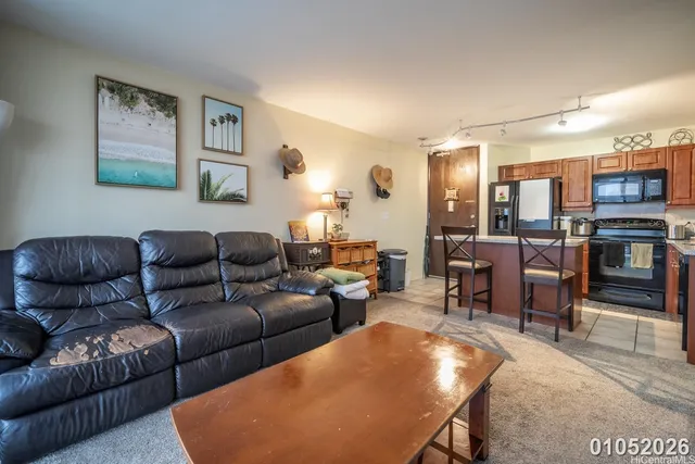 a living room with furniture kitchen view and a table