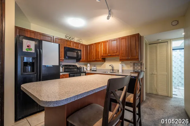 a kitchen with a table chairs refrigerator and cabinets