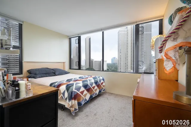 a bedroom with a bed and a night stand