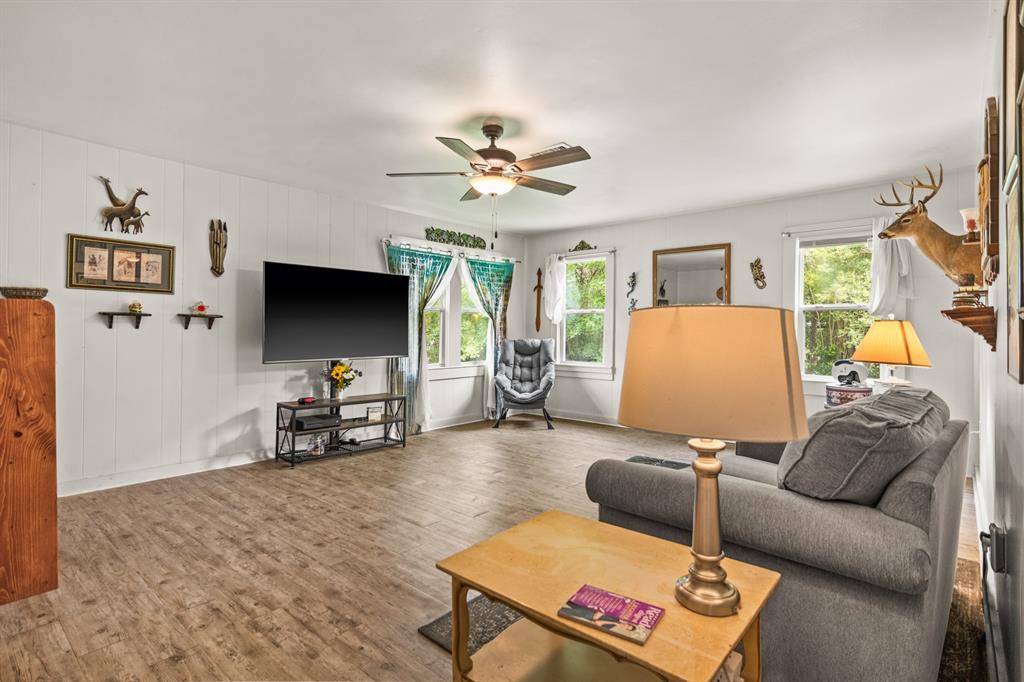 103 South Sun Camp Road White Oak, TX 75693 - Photo 26 of 40 a living room with furniture and a flat screen tv