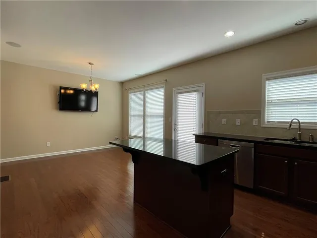 a kitchen with granite countertop a sink counter top space and a window