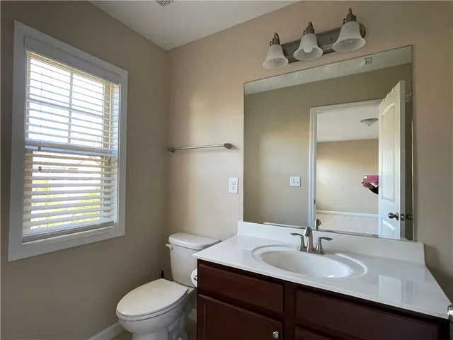 a bathroom with a sink mirror and a bathtub