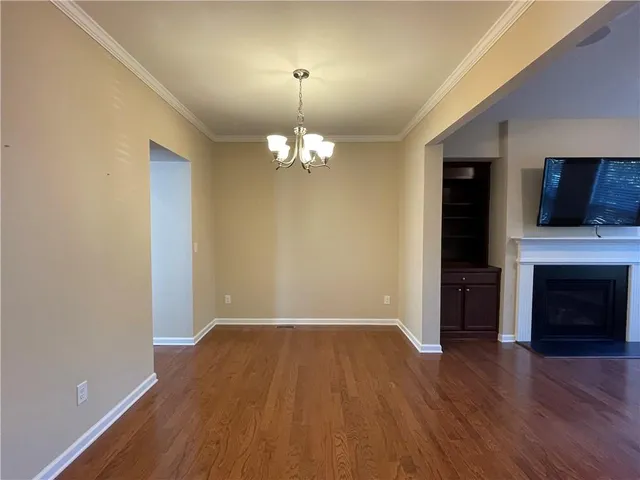wooden floor in an empty room with a fireplace