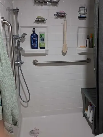 a bathroom with pair of shower