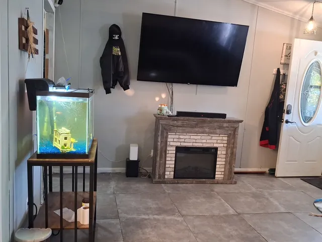 a living room with furniture a flat screen tv and a fireplace