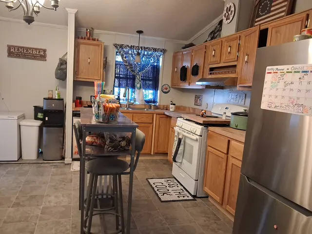 a kitchen with stainless steel appliances granite countertop a refrigerator and stove