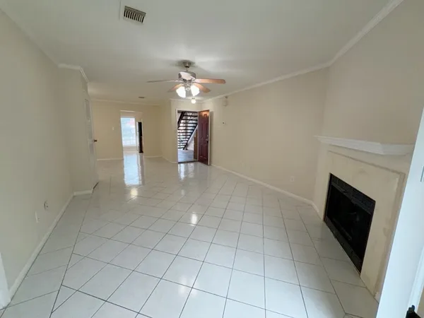 an empty room with fireplace and windows