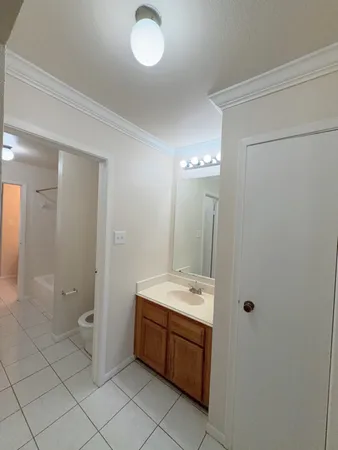a bathroom with a double vanity sink toilet and shower
