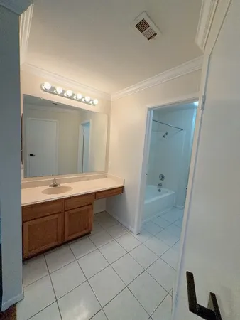a bathroom with a tub sink and mirror
