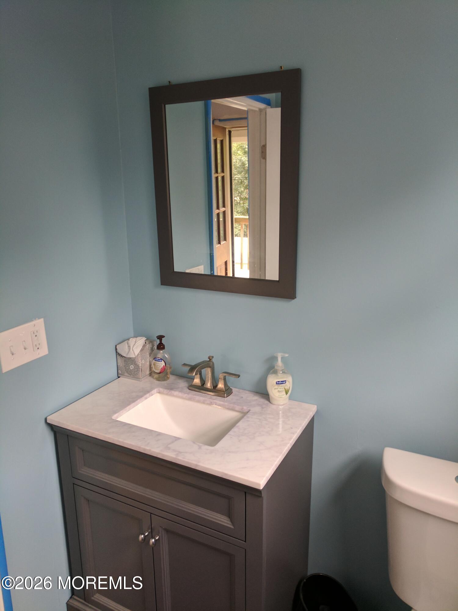 190 Jackson Street Matawan, NJ 07747 - Photo 18 of 24 a bathroom with a sink a toilet and mirror