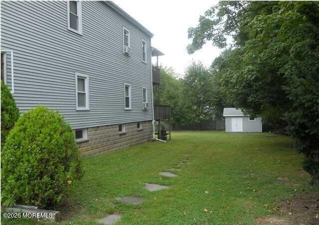 190 Jackson Street Matawan, NJ 07747 - Photo 22 of 24 a backyard of a house with plants and large tree