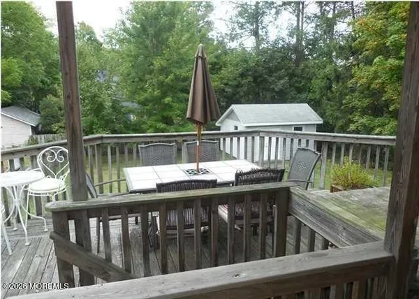 a view of a wooden deck with furniture
