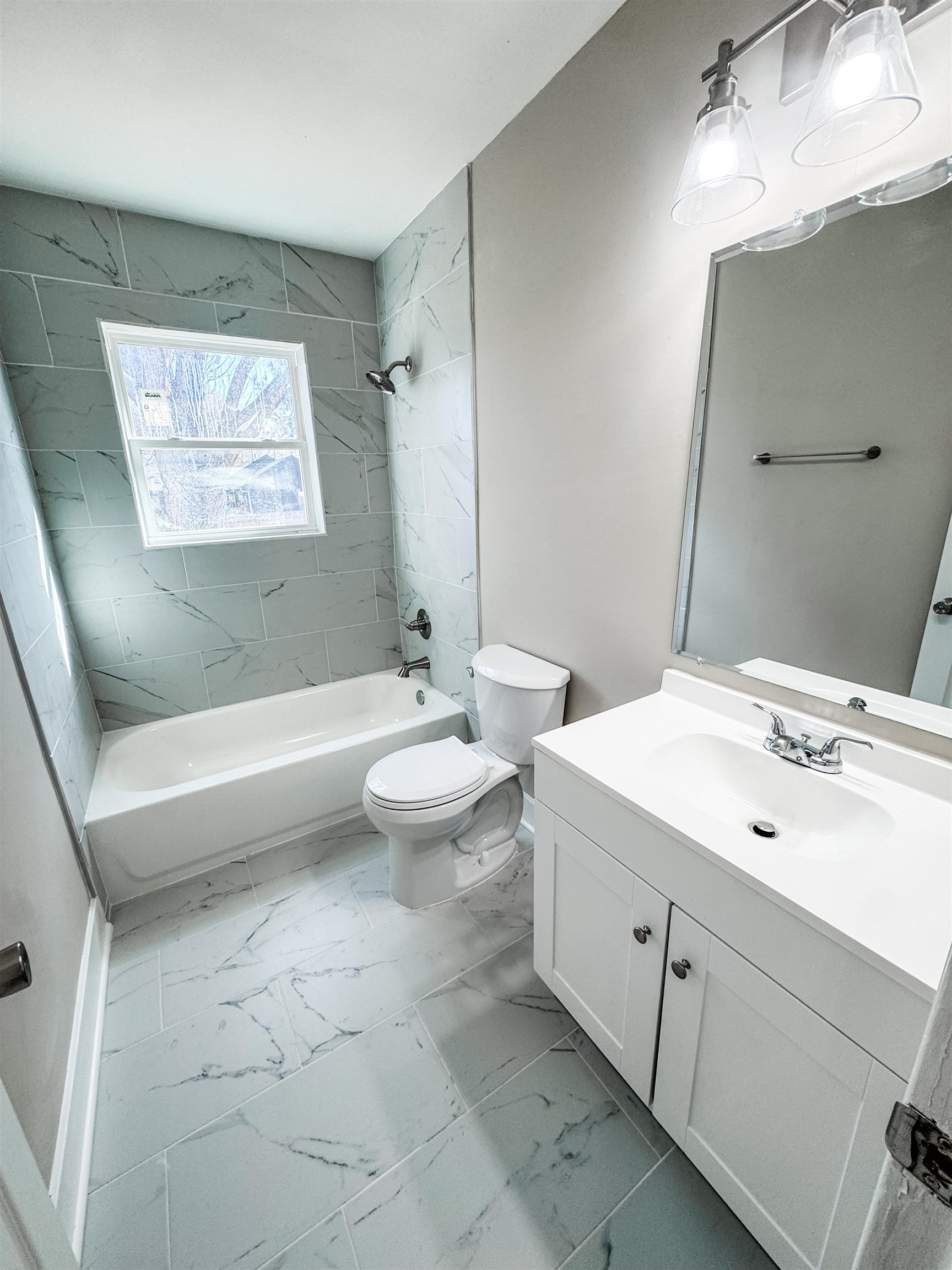 964 Greencliff Road Collierville, TN 38017 - Photo 4 of 7 Bathroom with vanity, light marble finish flooring, and bathing tub / shower combination