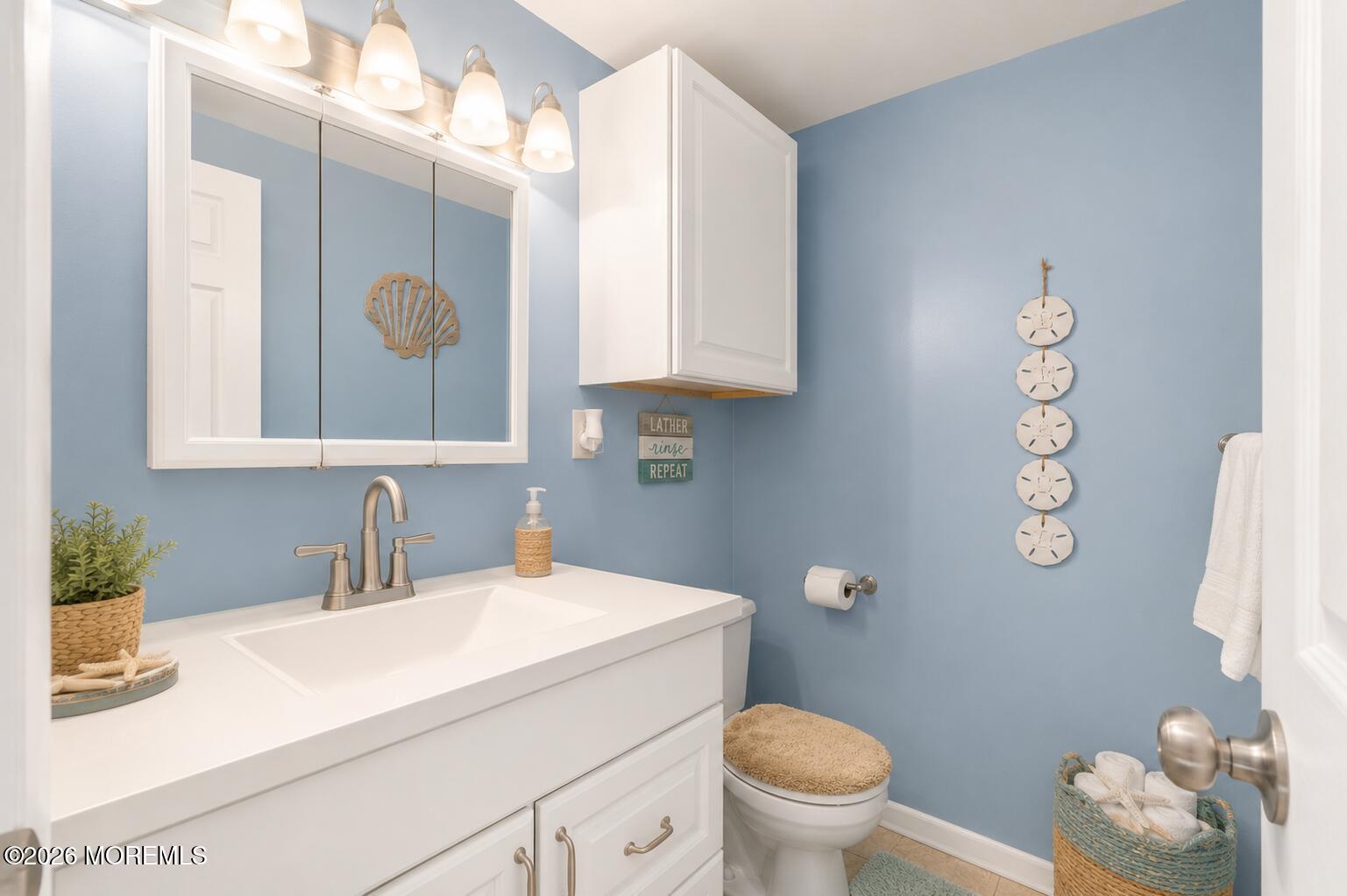 246 Cove Road Newport, NJ 08345 - Photo 5 of 21 a bathroom with a granite countertop sink mirror vanity and toilet
