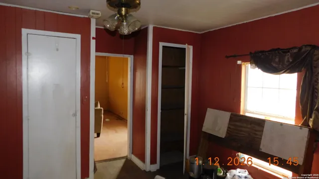 a view of hallway with furniture and chandelier