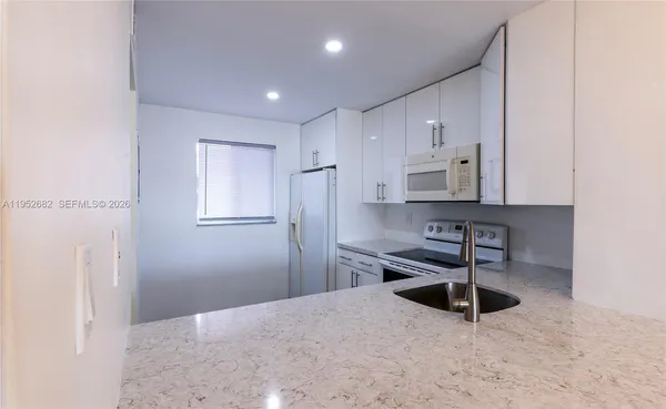 a kitchen with stainless steel appliances a refrigerator and a stove