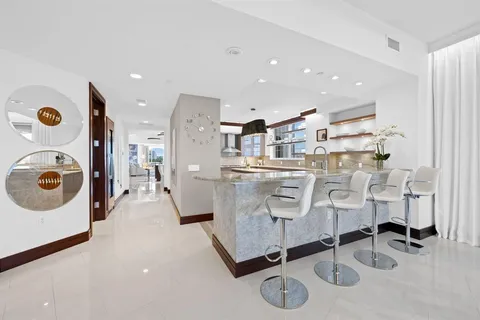 a bathroom with a granite countertop sink mirror vanity and toilet