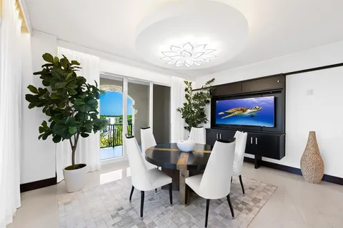 a living room with a bed furniture and a potted plant