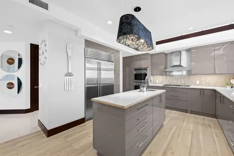 a view of a chairs and table in the balcony