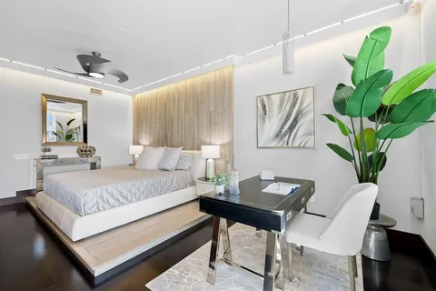 a bathroom with a double vanity sink toilet mirror and shower