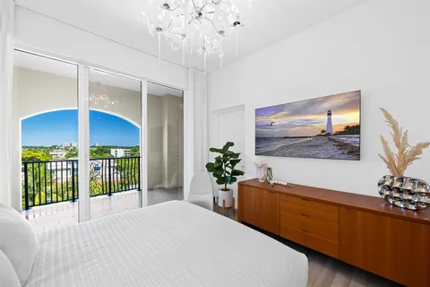 a living room with furniture a chandelier and a chandelier