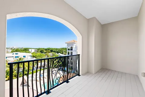 a view of a patio with a table and chairs under an umbrella