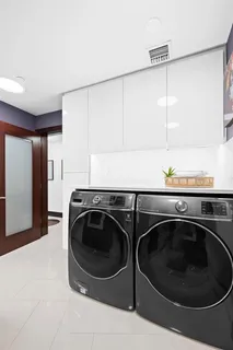 an aerial view of residential houses with outdoor space and trees