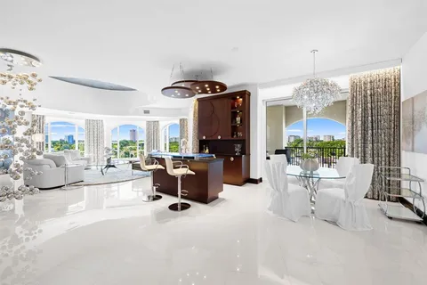 a kitchen with stainless steel appliances granite countertop a sink a stove and a refrigerator