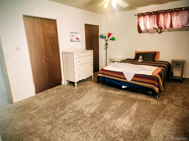 a bedroom with a bed and cabinets
